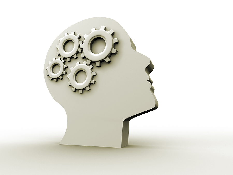 Vector diagram of a human head with 4 interconnecting gears in it.