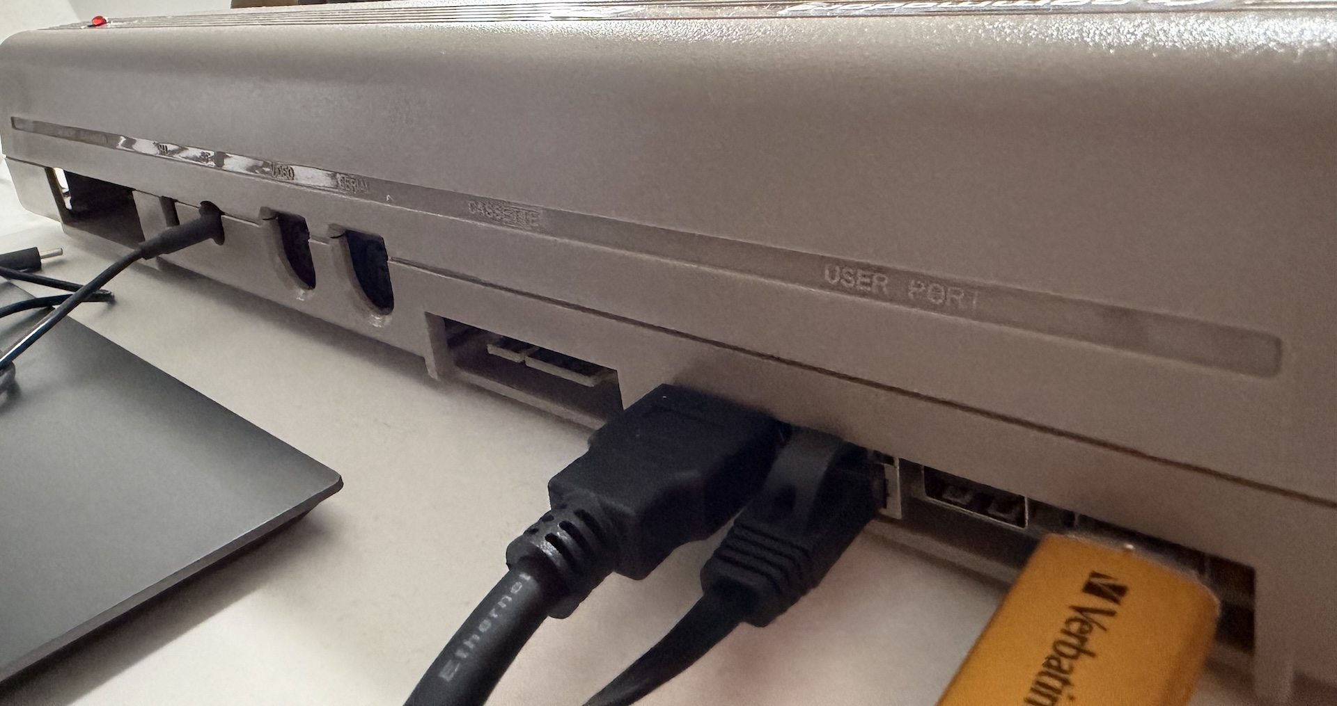 Rear view of the Commodore 64 Ultimate showing HDMI, ethernet, and USB plugged into the unit.