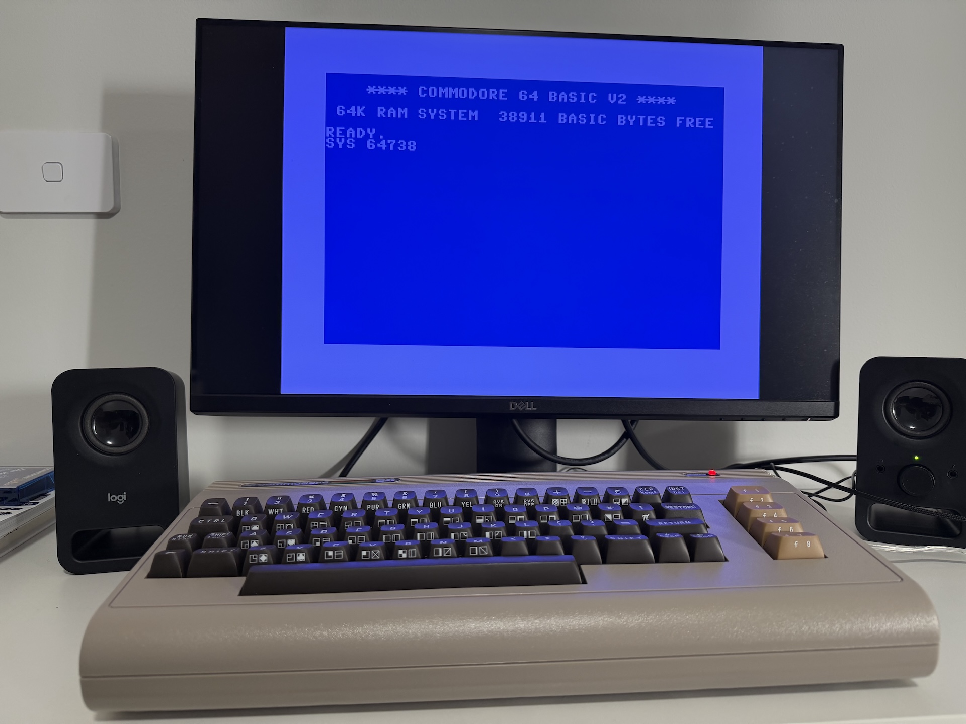 The classic Commodore 64 BASIC screen showing a command entered but not run, 'SYS 64738'